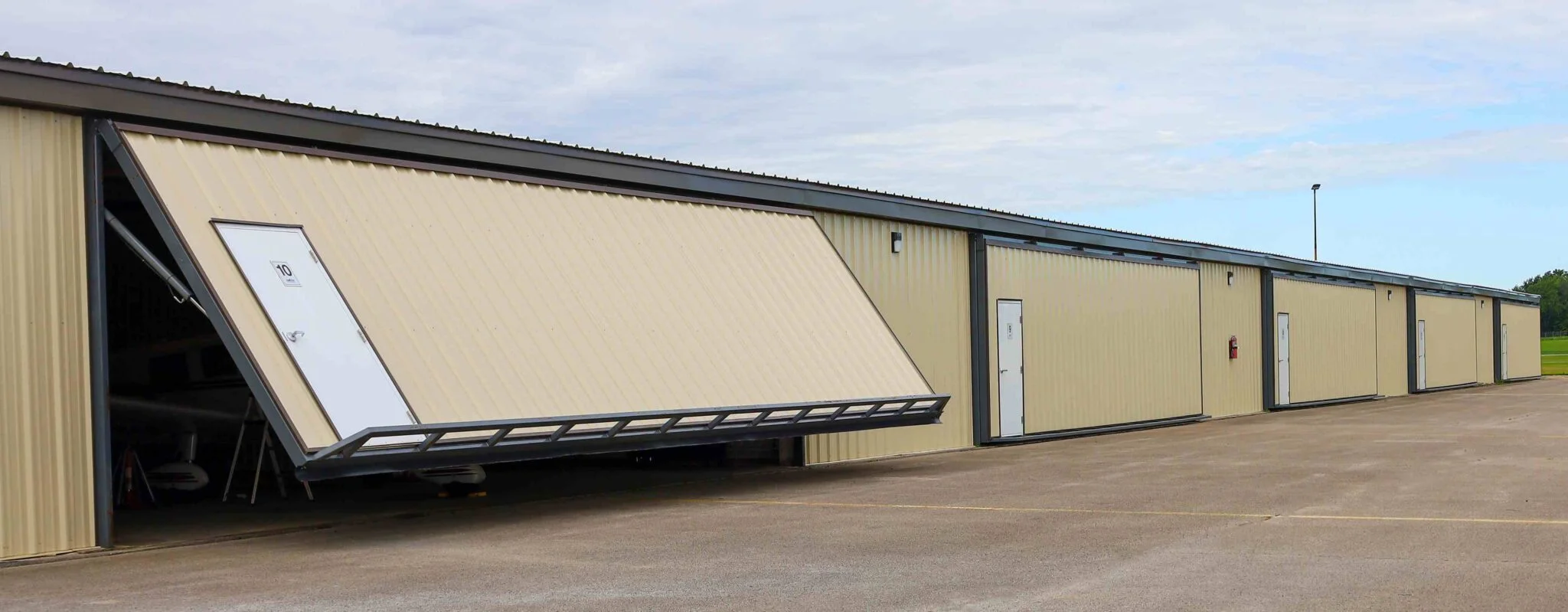 Hoogwaardige, winddichte, duurzame en moderne vliegtuighangardeuren van aluminiumlegering voor commercieel en residentieel gebruik.